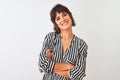 Young beautiful woman wearing striped shirt standing over isolated white background happy face smiling with crossed arms looking Royalty Free Stock Photo