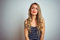 Young beautiful woman wearing stripes t-shirt standing over white isolated background smiling looking to the side and staring away Royalty Free Stock Photo