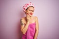 Young beautiful woman wearing towel and bath hat after shower over pink isolated background touching mouth with hand with painful Royalty Free Stock Photo