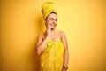 Young beautiful woman wearing towel after shower over isolated yellow background touching mouth with hand with painful expression Royalty Free Stock Photo