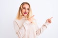 Young beautiful woman wearing turtleneck sweater standing over isolated white background smiling and looking at the camera Royalty Free Stock Photo