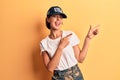 Young beautiful woman wearing usa cap smiling and looking at the camera pointing with two hands and fingers to the side Royalty Free Stock Photo