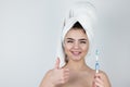 Young beautiful woman wearing white towel on her head holding tooth brush in one hand, showing like sign w on isolated white Royalty Free Stock Photo