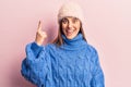 Young beautiful woman wearing winter clothes pointing finger up with successful idea Royalty Free Stock Photo