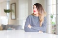 Young beautiful woman wearing winter sweater at home smiling looking side and staring away thinking Royalty Free Stock Photo