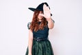 Young beautiful woman wearing witch halloween costume doing stop sing with palm of the hand