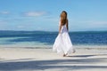 Young beautiful woman in wedding dress on tropical beach