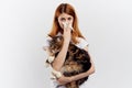 Young beautiful woman on white background holds a cat, an allergy to pets Royalty Free Stock Photo