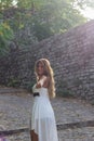 Beautiful woman wearing white dress on stone road Royalty Free Stock Photo