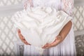 Young beautiful woman in a white dress posing  with a big white paper flower Royalty Free Stock Photo