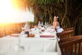 Young beautiful woman in white dress on the shore of the tropical sea in a cafe. travel and Summer concept Royalty Free Stock Photo