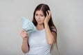 Young, beautiful woman in a white t-shirt with money in her hands  on a white background. Royalty Free Stock Photo