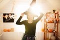 Young beautiful woman in witch costume ready for Halloween celebration in Halloween room decoration Royalty Free Stock Photo