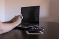 young beautiful woman working on laptop with cup of coffee, smartphone, tablet and notebook. Indoors. Work space. Royalty Free Stock Photo