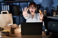 Young beautiful woman working using computer laptop and eating delivery food doing stop gesture with hands palms, angry and Royalty Free Stock Photo