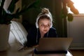 Young beautiful woman works for a computer from a home with a laptop as a freelancer Royalty Free Stock Photo