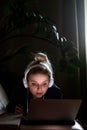 Young beautiful woman works for a computer from a home with a laptop as a freelancer Royalty Free Stock Photo