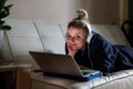 Young beautiful woman works for a computer from a home with a laptop as a freelancer Royalty Free Stock Photo