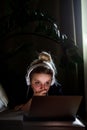 Young beautiful woman works for a computer from a home with a laptop as a freelancer Royalty Free Stock Photo