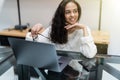 Young beautiful woman works for a computer from a home with a laptop on a white desk as a freelancer Royalty Free Stock Photo