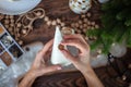 Young beautiful woman wrapping a foam cone with string yarn and crafting Christmas Tree