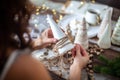 Young beautiful woman wrapping a foam cone with string yarn and crafting Christmas Tree