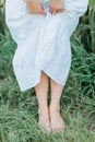 Young beautiful woman 26 years old in white simple dress in summer field. Green corn. Summer. Rustic style Royalty Free Stock Photo