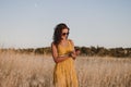 Young beautiful woman in yellow dress talking with mobile phone. Countryside. Outdoors. Travel concept. Sunset Royalty Free Stock Photo