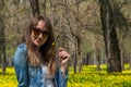 Young beautiful woman in the yellow field in Central park in Almaty, Kazakhstan