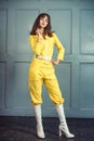 Young beautiful woman in yellow work suit