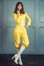 Young beautiful woman in yellow work suit