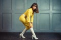 Young beautiful woman in yellow work suit