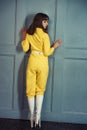 Young beautiful woman in yellow work suit