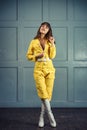 Young beautiful woman in yellow work suit