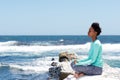 Young beautiful woman in yoga pose at the beach Royalty Free Stock Photo