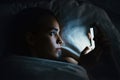 Young beautiful womanl in bed using mobile phone late at night at dark bedroom, internet addiction concept Royalty Free Stock Photo