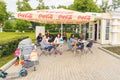 young beautiful women with children are resting in a summer cafe on the embankment of the Volga River in a summer sunny day