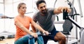 Young beautiful woman doing exercises with personal trainer