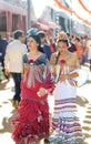 Young and beautiful women dressed in traditional costumes at the Seville`s April Fair.