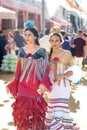 Young and beautiful women dressed in traditional costumes at the Seville`s April Fair