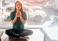 Young beautiful woman drinking coffee at cafe bar. Female model in the morning at restaurant Royalty Free Stock Photo