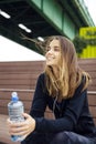 Young beautiful women resting and drinking water after doing exercises Royalty Free Stock Photo