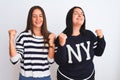 Young beautiful women wearing casual clothes standing over isolated white background very happy and excited doing winner gesture Royalty Free Stock Photo