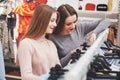 Young beautiful women at the weekly cloth market - Best friends sharing free time having fun and shopping Royalty Free Stock Photo