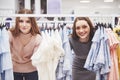 Young beautiful women at the weekly cloth market - Best friends sharing free time having fun and shopping in the old Royalty Free Stock Photo