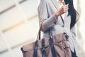 Young beautiful working woman holding bag in the city