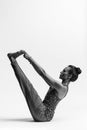 Young beautiful yoga female posing in studio