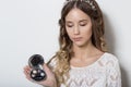 Young beautiful young girl with long curly hair, no makeup with a clean face with a wreath on his head portrait in the studio on a Royalty Free Stock Photo