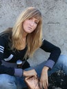 Young beautifull girl against stucco wall