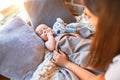 Young beautifull woman and her baby on the floor over blanket at home